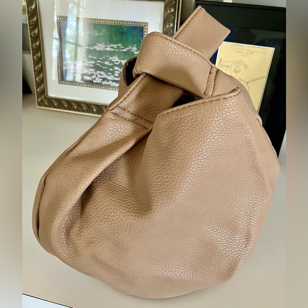 Tan Tote Drop handbag. Unique and easy to carry, Super cute, never used